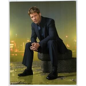 V Joel Gretsch Press Photo Actor Seated on Tires in Urban Night Scene